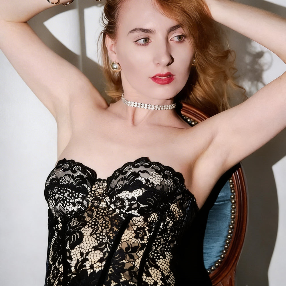 Woman wearing a black lace dress with a white background